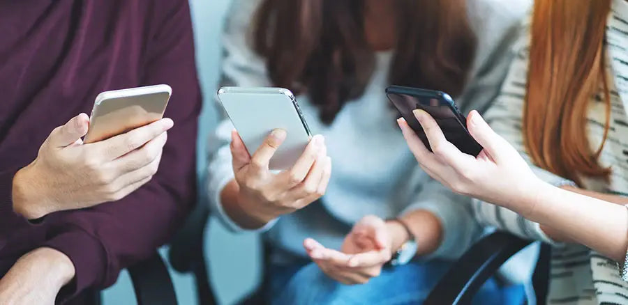 Customer checking Samsung and Google phones during in-store buying process